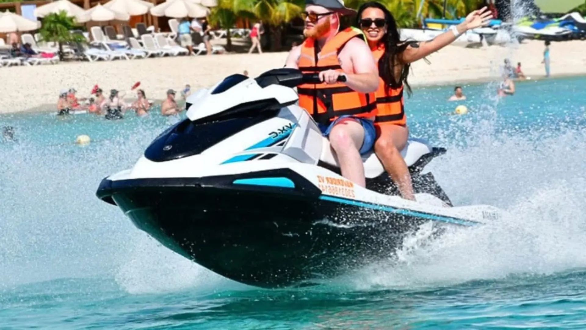 Couple riding a jet ski at a Cozumel beach club